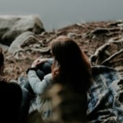 couple-sitting-by-lake